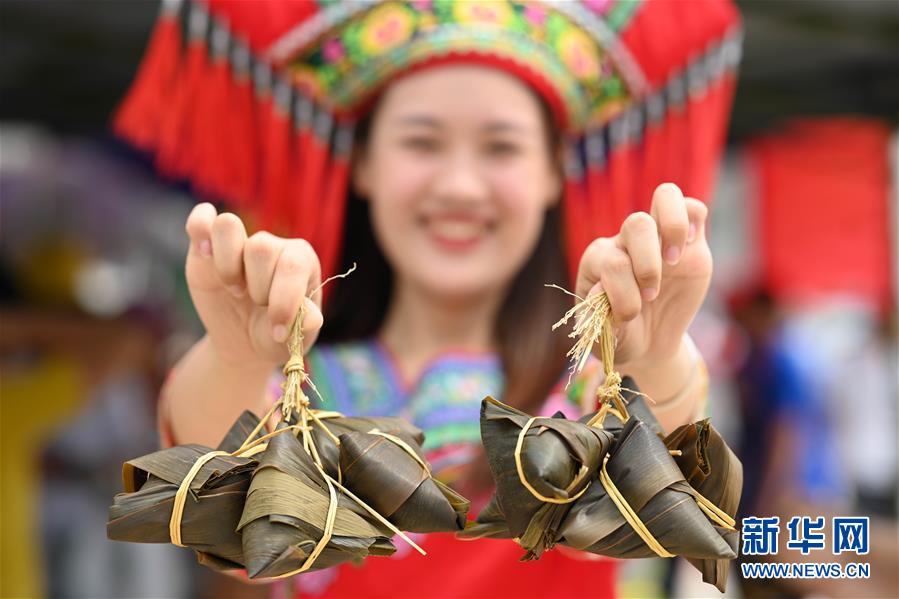 6月22日，在廣西柳州市柳江區(qū)進(jìn)德鎮(zhèn)泗浪村紅花屯，村民展示剛包好的粽子。 端午節(jié)將至，各地舉辦包粽子比賽、制作香囊等民俗活動(dòng)，感受傳統(tǒng)節(jié)日的魅力。 新華社發(fā)（黎寒池 攝）