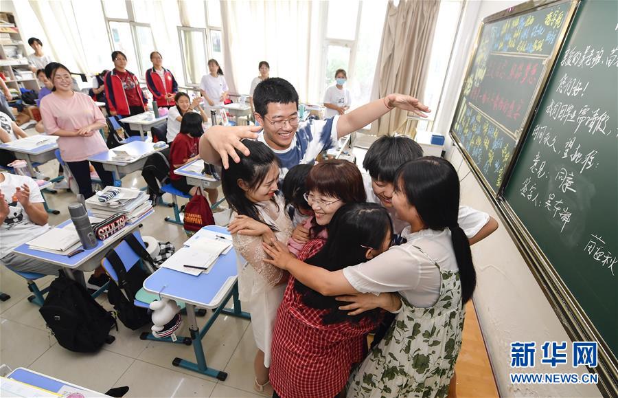 7月6日，吉林省孤兒學(xué)校高三年級(jí)學(xué)生與班主任吳東輝相擁慶祝畢業(yè)。 新華社記者 許暢 攝