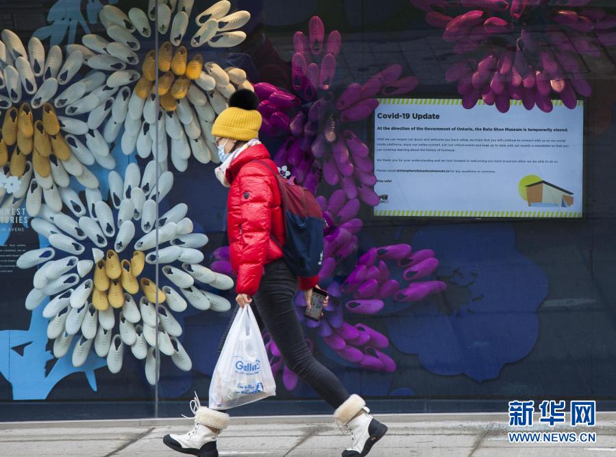 11月23日，在加拿大多倫多，一名戴口罩的行人路過一家關(guān)閉的博物館。當日，加拿大新增新冠確診病例5119例，多倫多等地因疫情上升再度“封城”。新華社發(fā)（鄒崢攝）
